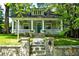 Charming home with a welcoming front porch, stone stairs, and lush green lawn at 630 Cleburne Ne Ter, Atlanta, GA 30306