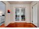 Hallway with hardwood floors, glass French doors leading to an office and bedroom, and neutral walls at 630 Cleburne Ne Ter, Atlanta, GA 30306