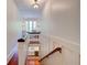 Upstairs hallway with reading nook, hardwood floors, and natural light at 630 Cleburne Ne Ter, Atlanta, GA 30306