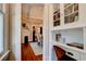 Hallway view of a dining room with a fireplace and hardwood floors with built-in shelving at 630 Cleburne Ne Ter, Atlanta, GA 30306
