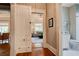 Hallway with hardwood floors leading to a modern bathroom and living room at 630 Cleburne Ne Ter, Atlanta, GA 30306