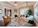 Cozy living room with hardwood floors, white fireplace, white trim, and large windows at 630 Cleburne Ne Ter, Atlanta, GA 30306