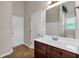 Well-lit bathroom featuring a single sink vanity with a large mirror and a shower/tub combo at 845 Nevis Way, Mcdonough, GA 30253
