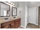 Bathroom featuring a double sink vanity with dark wood cabinets and tile flooring at 845 Nevis Way, Mcdonough, GA 30253
