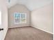 Cozy carpeted bedroom with a large window offering natural light and a high vaulted ceiling at 845 Nevis Way, Mcdonough, GA 30253