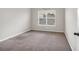 Bright bedroom featuring carpet flooring and a window that brings in natural light at 845 Nevis Way, Mcdonough, GA 30253