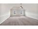 Spacious carpeted bedroom featuring a vaulted ceiling with a ceiling fan and natural light from two windows at 845 Nevis Way, Mcdonough, GA 30253