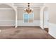 Open dining room with crown molding, elegant chandelier, and great natural light at 845 Nevis Way, Mcdonough, GA 30253