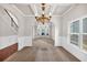 Inviting dining room with coffered ceilings, elegant chandelier, and large windows at 845 Nevis Way, Mcdonough, GA 30253