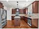 Kitchen featuring an island with granite countertops, stainless steel appliances, and beautiful wood floors at 845 Nevis Way, Mcdonough, GA 30253