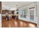 Well-lit kitchen featuring wood floors, matching cabinetry, an island, and stainless steel appliances at 845 Nevis Way, Mcdonough, GA 30253