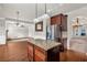 Open-concept kitchen features granite countertops, stainless steel appliances, and hardwood floors at 845 Nevis Way, Mcdonough, GA 30253