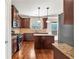 Well-equipped kitchen with wooden cabinets, central island, tile backsplash, and hardwood floors at 845 Nevis Way, Mcdonough, GA 30253
