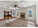 Open-concept living room with fireplace flows into kitchen; features coffered ceiling at 845 Nevis Way, Mcdonough, GA 30253