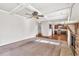 Open-concept living room with fireplace flows into kitchen; features coffered ceiling at 845 Nevis Way, Mcdonough, GA 30253