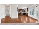 Open floor plan highlighting hardwood floors, adjacent kitchen, and natural light at 845 Nevis Way, Mcdonough, GA 30253