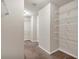 Bright walk-in closet featuring carpet flooring and white wire shelving at 845 Nevis Way, Mcdonough, GA 30253