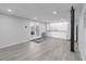 Walkout basement with recessed lighting, kitchenette, and gray wood-look flooring at 935 Old Loganville Rd, Loganville, GA 30052