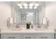 Bathroom featuring double sinks, white cabinets, and a large mirror at 935 Old Loganville Rd, Loganville, GA 30052