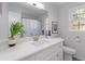 Bright bathroom features a quartz countertop, sink, toilet, and a large window at 935 Old Loganville Rd, Loganville, GA 30052