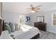 Relaxing bedroom featuring a queen-sized bed, ceiling fan, and modern decor at 935 Old Loganville Rd, Loganville, GA 30052