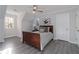 Inviting bedroom boasts natural light, gray wood floors, ceiling fan and stylish decor at 935 Old Loganville Rd, Loganville, GA 30052
