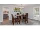 Bright dining room with modern furnishings and access to kitchen at 935 Old Loganville Rd, Loganville, GA 30052