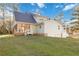 Back exterior view of the home with screened porch, decks, and landscaped yard at 935 Old Loganville Rd, Loganville, GA 30052