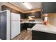 Traditional kitchen with dark cabinetry, laminate countertops, and a modern refrigerator at 935 Old Loganville Rd, Loganville, GA 30052