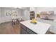Bright kitchen with island, white cabinets, stainless appliances, and breakfast area at 935 Old Loganville Rd, Loganville, GA 30052
