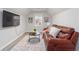 Comfortable living room with leather sofa, ceiling fan, and large television screen at 935 Old Loganville Rd, Loganville, GA 30052