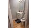 A cozy bathroom boasts a white vanity, decorative mirror and hardwood flooring at 1425 Parkmont Dr, Roswell, GA 30076