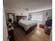 Bedroom with a large bed, hardwood floors, and a window offering natural light at 1425 Parkmont Dr, Roswell, GA 30076