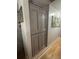 Hallway with gray storage and hardwood flooring with wall art at 1425 Parkmont Dr, Roswell, GA 30076