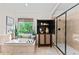 Bright bathroom with soaking tub and separate glass shower, complemented by stylish cabinet and greenery at 1771 Silvergrass Ln, Grayson, GA 30017