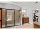 Elegant bathroom with glass-enclosed shower, vanity with granite countertop, and access to walk-in closet at 1771 Silvergrass Ln, Grayson, GA 30017