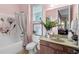 Cozy full bathroom with vanity, shower/tub combo, and a window providing plenty of natural light at 1771 Silvergrass Ln, Grayson, GA 30017