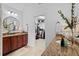 Double vanities with granite counters, and walk-in closet access in bright bathroom at 1771 Silvergrass Ln, Grayson, GA 30017