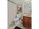 A quaint bathroom features neutral tiling, classic vanity, and stylish shower curtain at 1771 Silvergrass Ln, Grayson, GA 30017