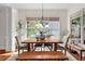 Sunny dining area with a large window, hardwood floors, and a stylish chandelier at 1771 Silvergrass Ln, Grayson, GA 30017