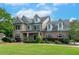Beautiful exterior home elevation with a large yard, professional landscaping, and inviting curb appeal at 1771 Silvergrass Ln, Grayson, GA 30017