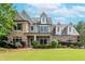 Charming two-story home with a manicured lawn, professional landscaping and mixed brick and stacked stone details at 1771 Silvergrass Ln, Grayson, GA 30017