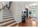 Traditional foyer featuring hardwood floors, stairs, and elegant lighting fixture at 1771 Silvergrass Ln, Grayson, GA 30017