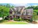 Charming two-story home with brick and stone facade, well-manicured landscaping at 1771 Silvergrass Ln, Grayson, GA 30017
