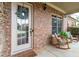 Inviting front porch with brickwork, rocking chairs, decor, and a welcoming entrance to the home at 1771 Silvergrass Ln, Grayson, GA 30017