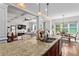 Open-concept kitchen with granite countertops, stainless steel appliances, and views into the living room at 1771 Silvergrass Ln, Grayson, GA 30017