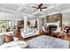 Open-concept living room has coffered ceilings, a stone fireplace, and large windows for lots of light at 1771 Silvergrass Ln, Grayson, GA 30017