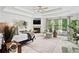 Spacious main bedroom featuring a fireplace, tray ceiling, and ample natural light from large windows at 1771 Silvergrass Ln, Grayson, GA 30017