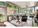 Relaxing screened-in porch with comfortable seating, natural light, and views of the backyard at 1771 Silvergrass Ln, Grayson, GA 30017
