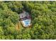 Secluded estate nestled among mature trees, featuring a backyard pool and patio at 180 Mountain Path, Rockmart, GA 30153